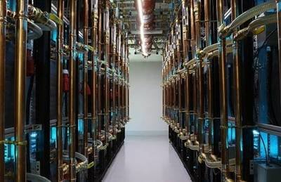 Interior of a mining farm with rows of mining rigs