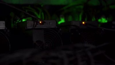 A sprawling mining farm integrated with modern wind turbines